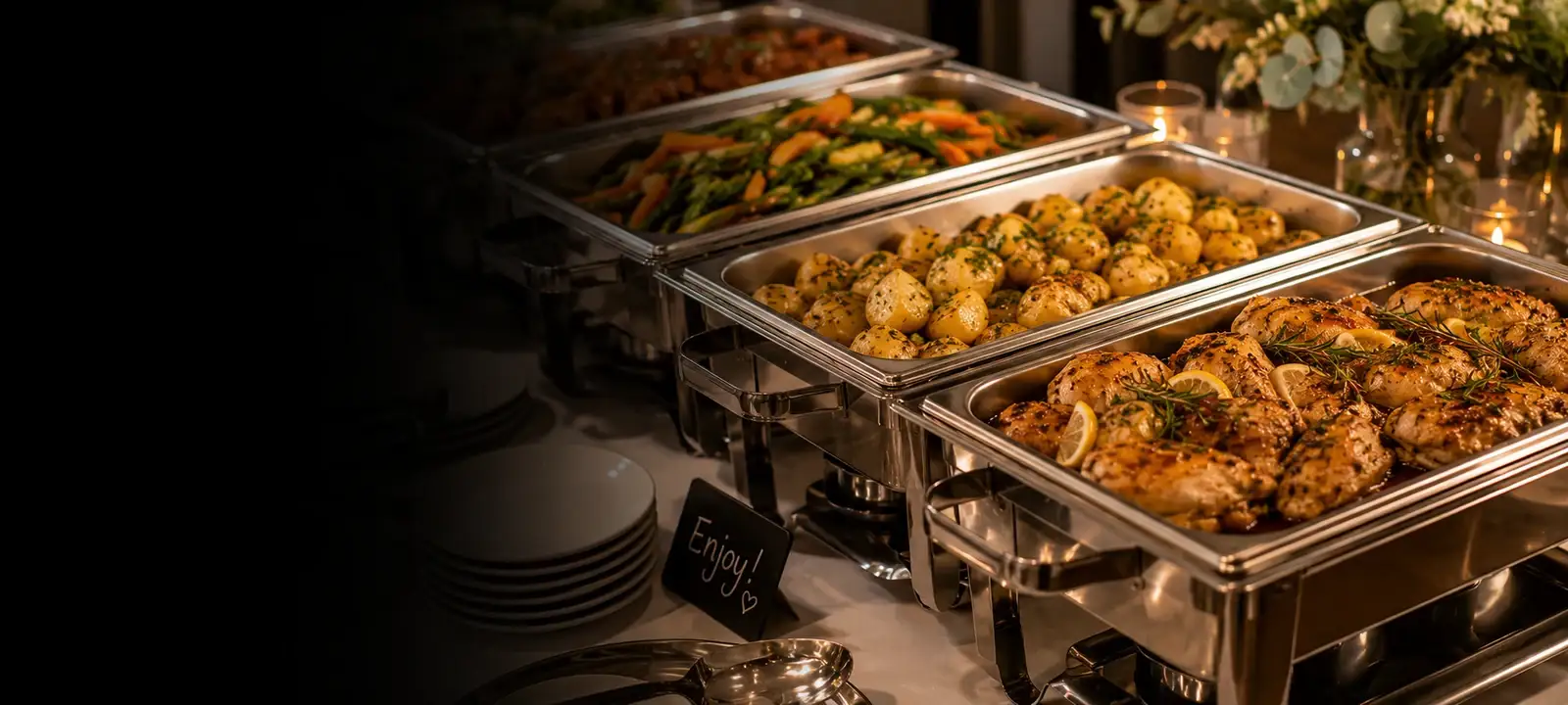 Hot buffet spread laid out on a table with serving spoons ready