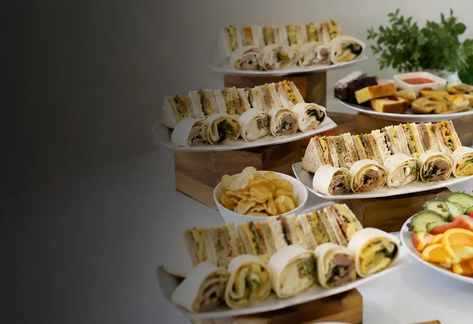Platters of freshly made sandwiches laid out on a buffet table