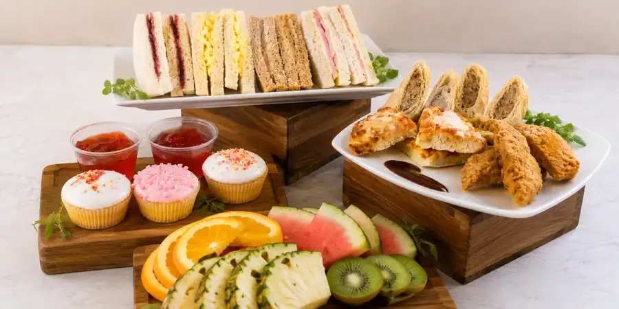 Children's party buffet with sandwiches, mini pizzas and jelly pots
